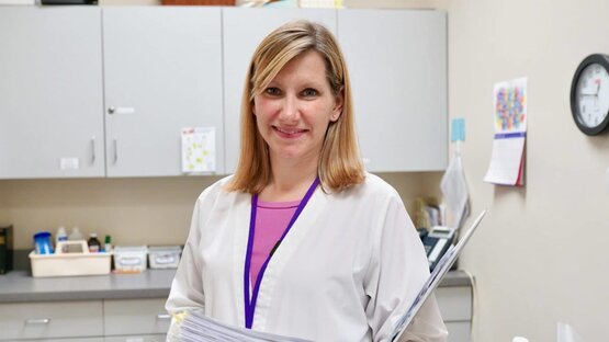 The School Nurse standing in the Nurse's office.